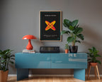 Möbius cross wall art above a blue console with plants