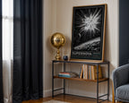 SN 1987A supernova print styled on a black console beside a gold lamp