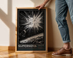 Person holding an SN 1987A supernova print to show its scale