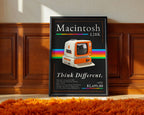 Retro Macintosh 128K print displayed against wood paneling